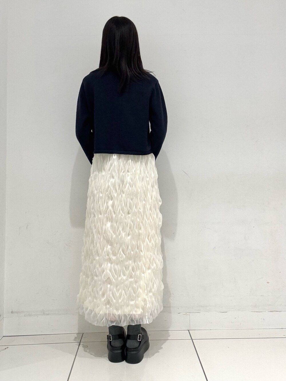 ブルー系のカーディガン/ボレロ、ホワイト系のTシャツ/カットソー、ホワイト系のスカートを着用したレディースの冬コーディネートの3枚目の写真