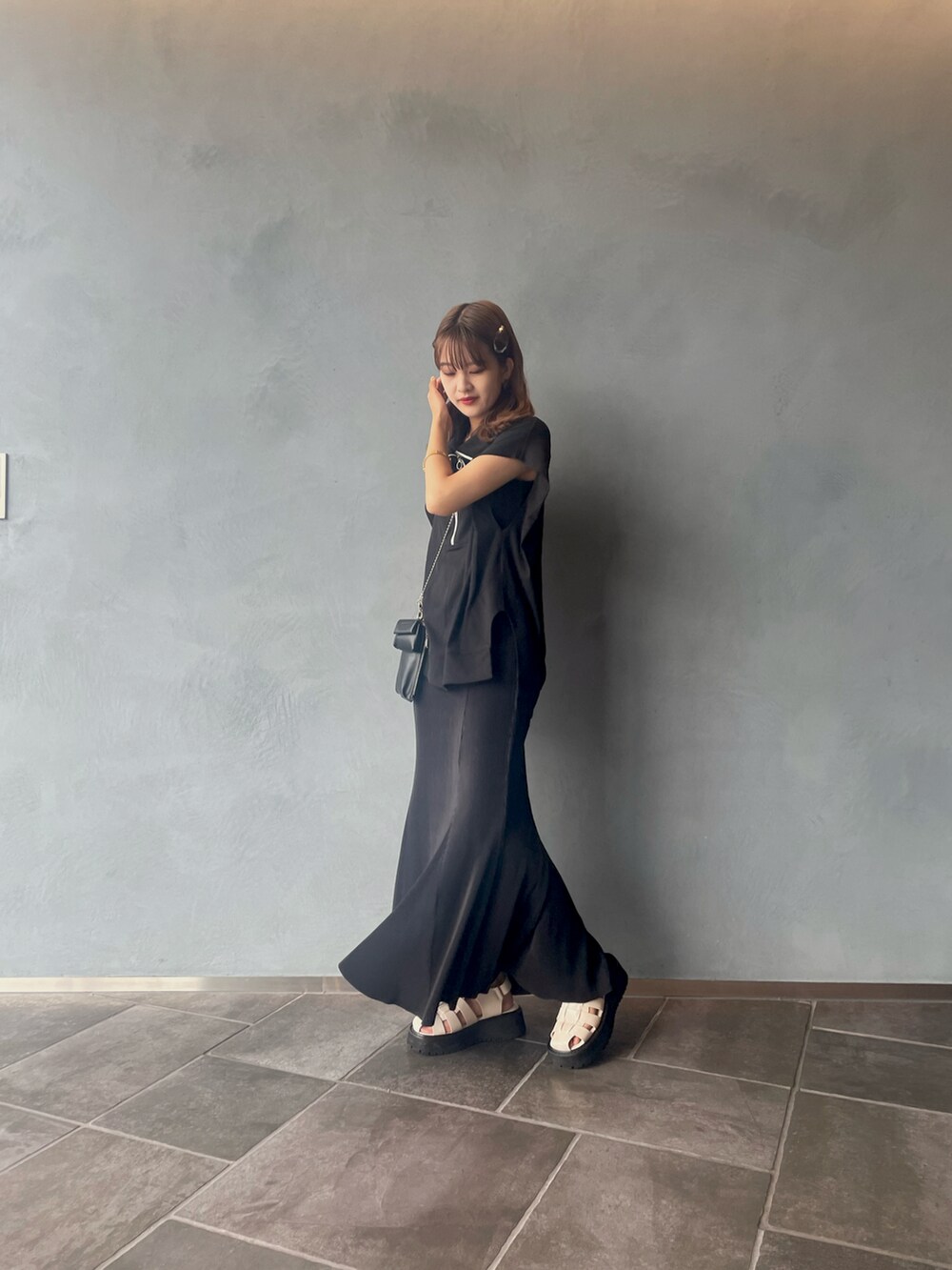 ブラック系のスカート、ブラック系のTシャツ/カットソーを着用したレディースの夏コーディネートの3枚目の写真