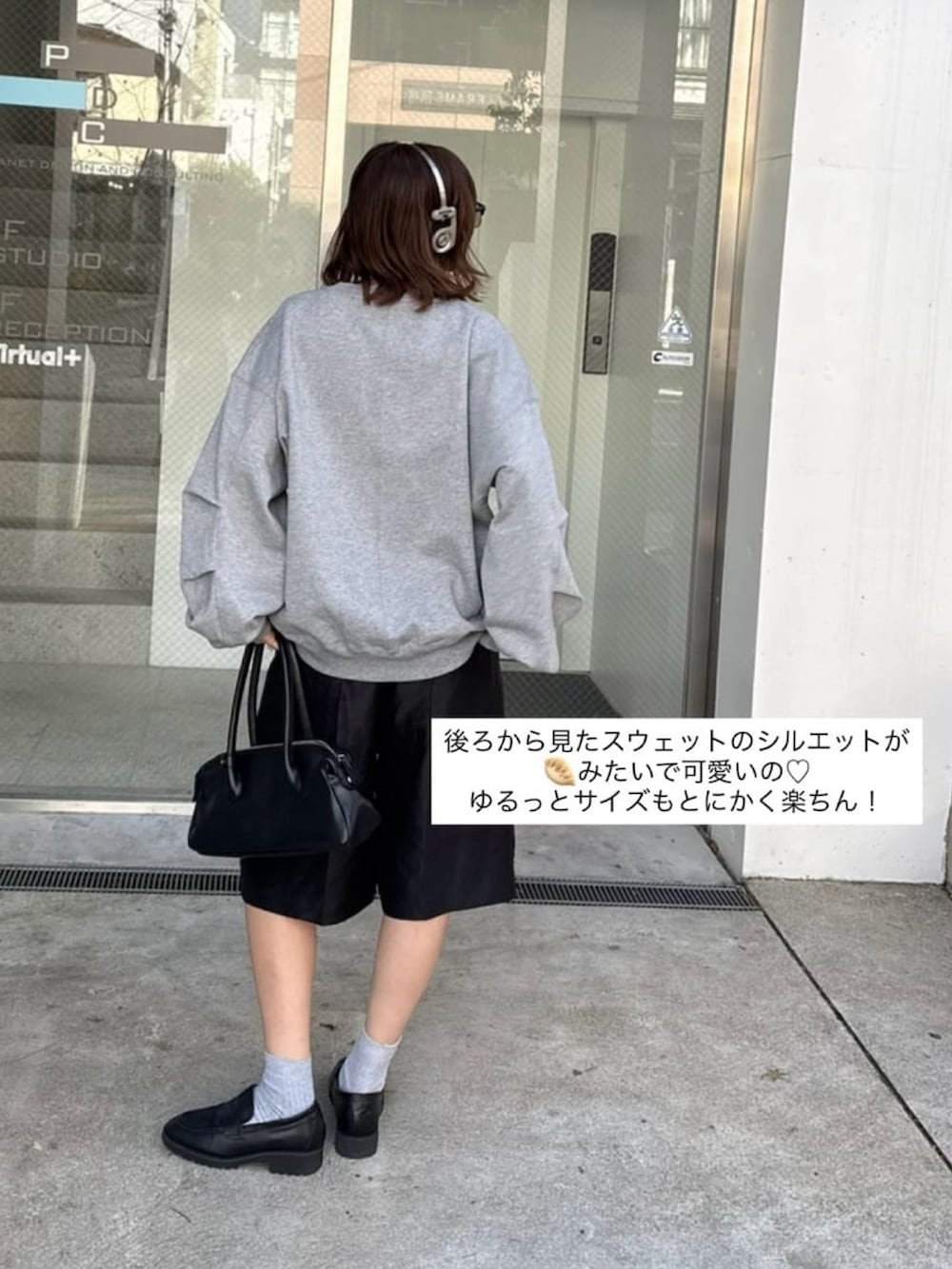 ホワイト系のスウェット、ブラック系のトートバッグを着用したレディースの冬コーディネートの2枚目の写真