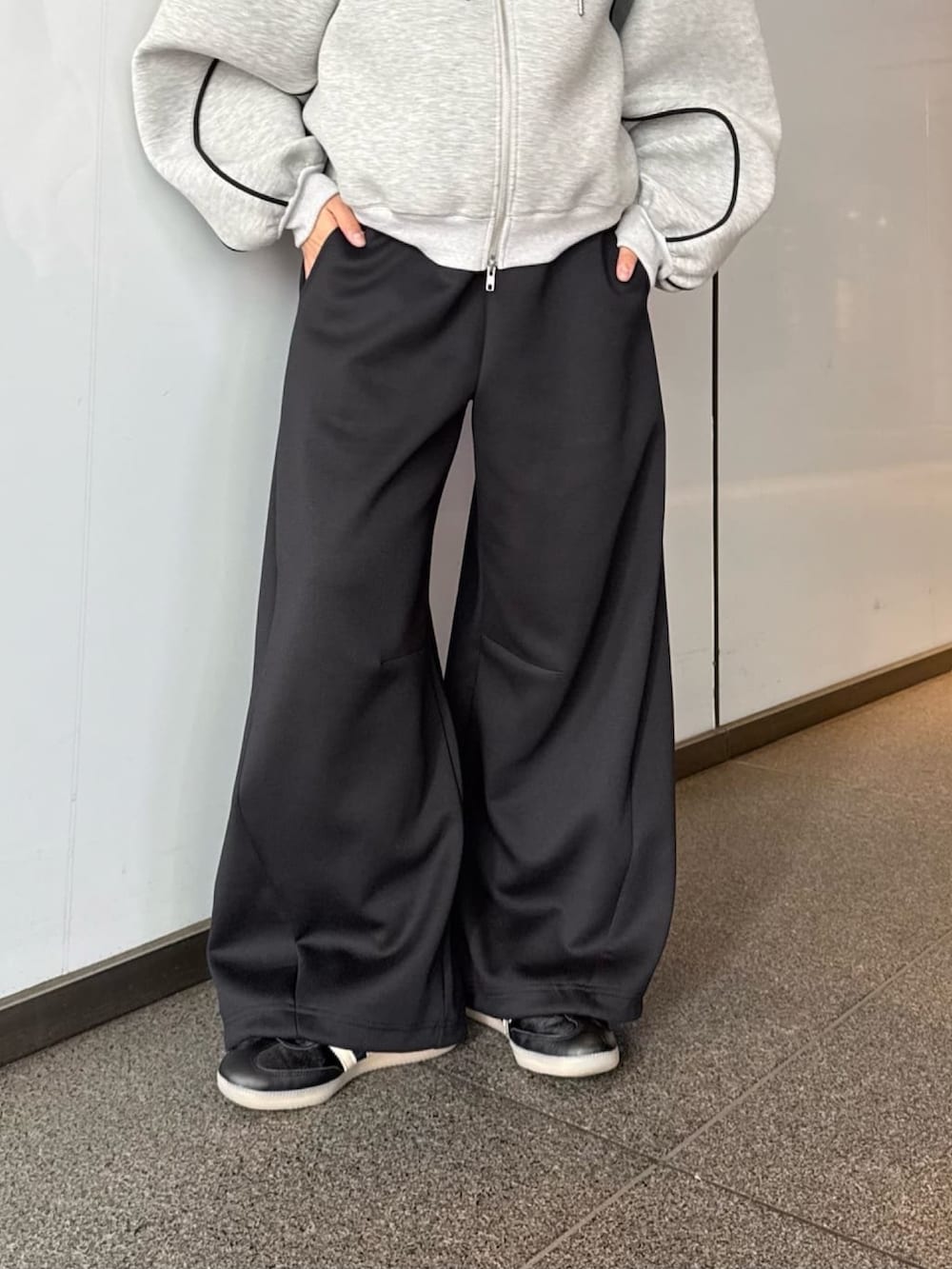 グレー系のパーカー、グレー系のその他パンツ、ブラック系のサングラスを着用したレディースの春コーディネートの3枚目の写真