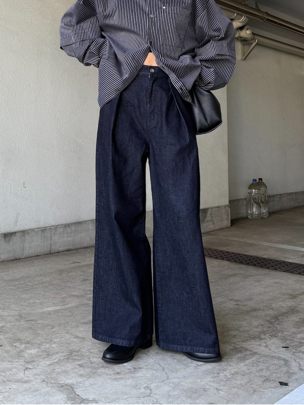 グレー系のニット/セーター、ブルー系のデニムパンツ、ブラック系のサングラスを着用したレディースの秋コーディネートの3枚目の写真