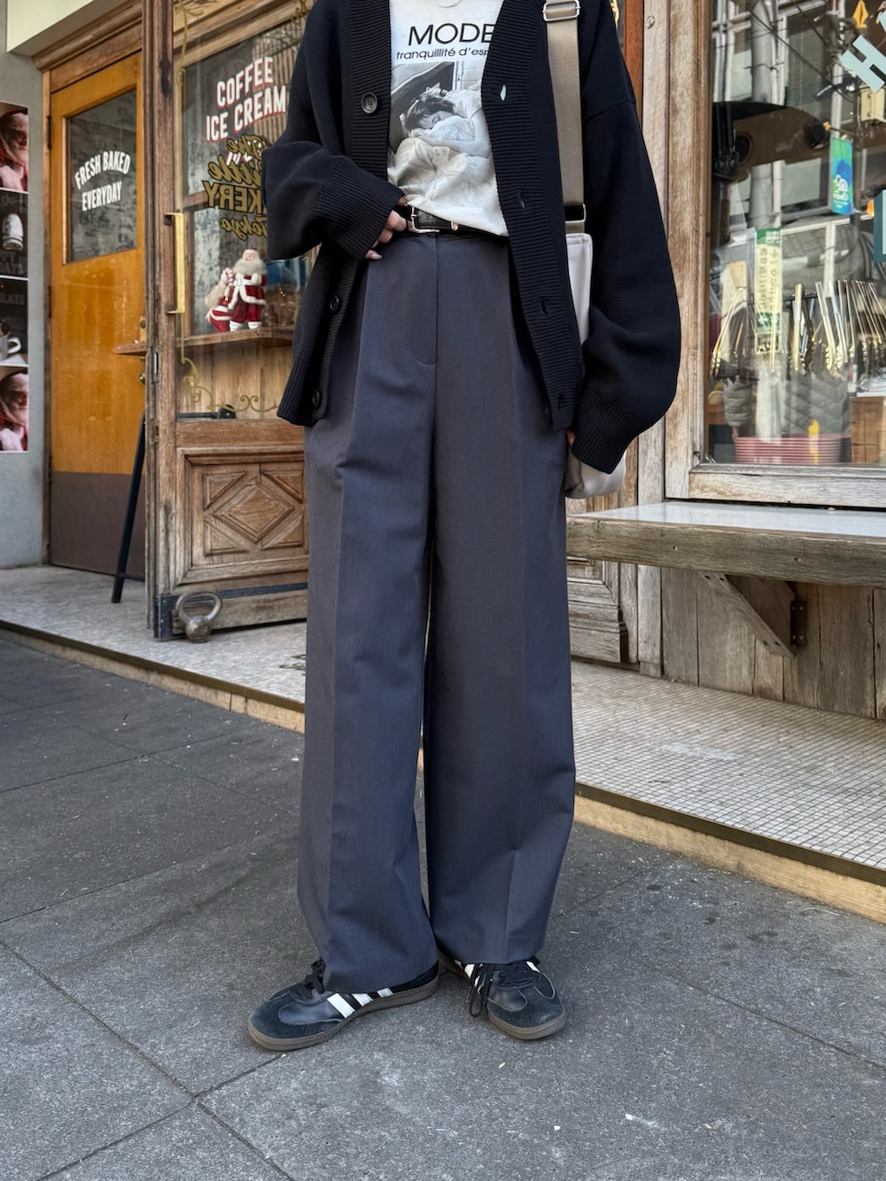 ブラック系のカーディガン/ボレロ、グレー系のショルダーバッグ、ブラック系のスラックスを着用したレディースの冬コーディネートの2枚目の写真