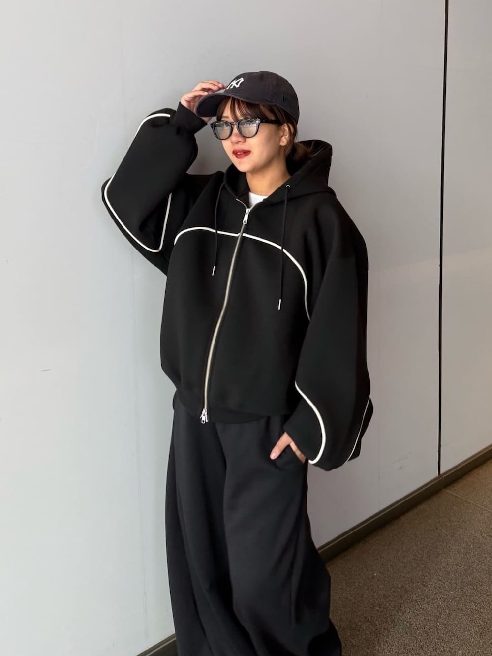 グレー系のその他パンツ、グレー系のパーカー、ブラック系のサングラスを着用したレディースの春コーディネートの5枚目の写真