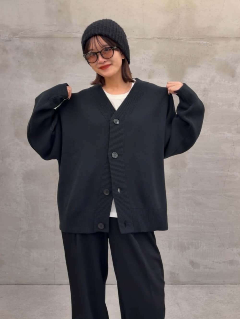ブラック系のカーディガン/ボレロ、ブラック系のスラックスを着用したレディースの秋コーディネートの3枚目の写真