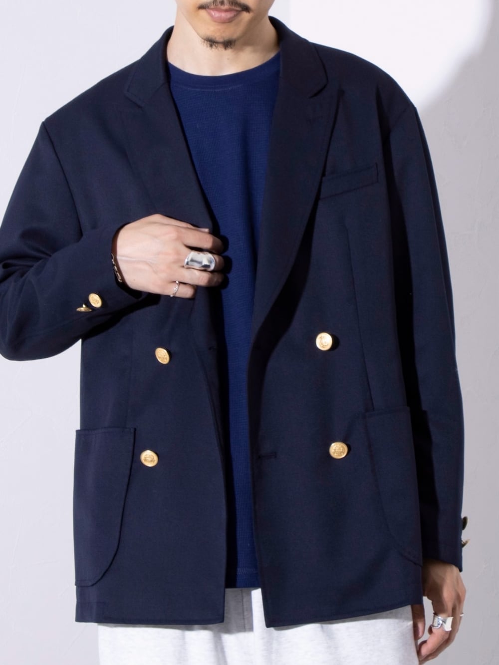 ブルー系のテーラードジャケット、ブルー系のTシャツ/カットソー、ベージュ系のスウェットパンツを着用したメンズの秋コーディネートの2枚目の写真