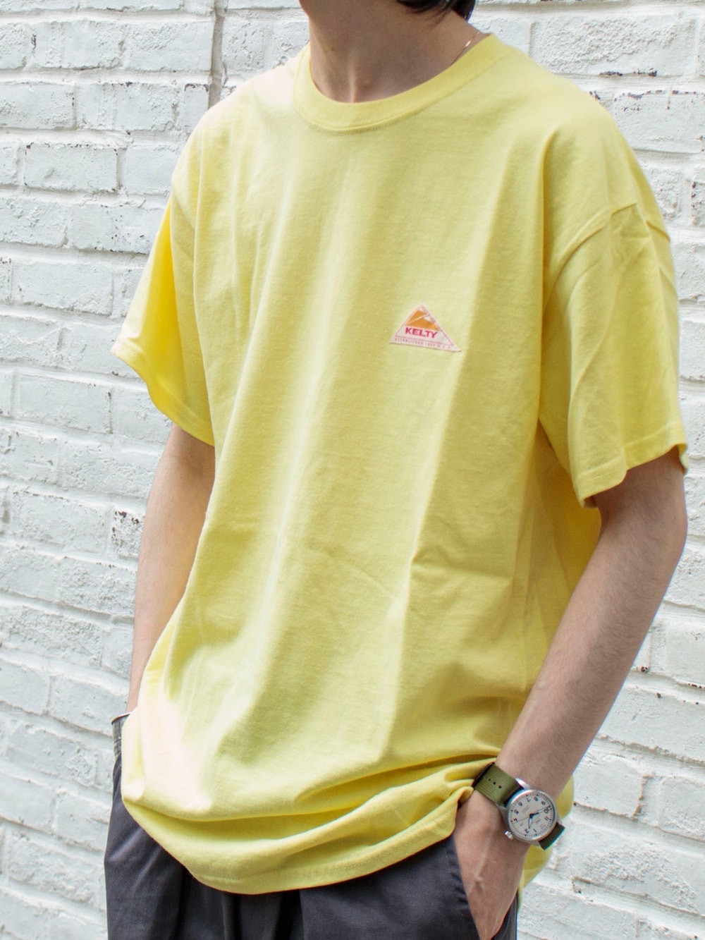 「大人カジュアル、シンプルコーデ、キャップ、春夏コーデ、夏コーデ、ブーツ、Tシャツ、休日スタイル、ケルティ、gloster、ビッグシルエット、シェフパンツ、FREDY&GLOSTER、イエロー」｜「KELTYの【KELTY/ケルティ】別注バックプリント ビッグシルエットショートスリーブTシャツ（Tシャツ/カットソー、イエロー系）」を使った、須山さん（メンズ・177cm）の春コーディネートの2枚目の写真