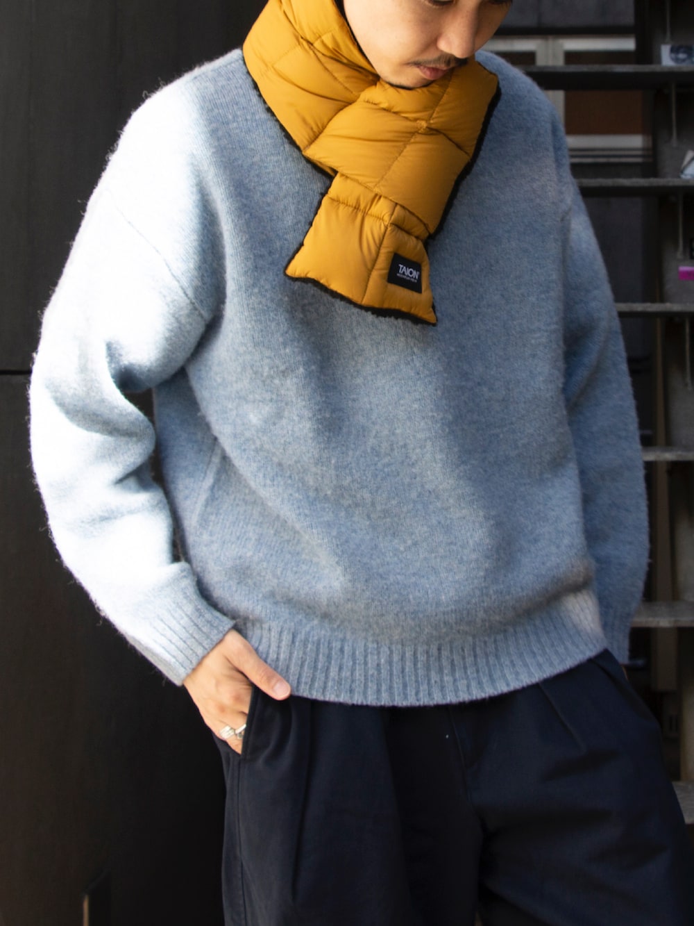 ブルー系のニット/セーター、ブルー系のチノパンツ、ブルー系のスニーカーを着用したメンズの秋コーディネートの2枚目の写真