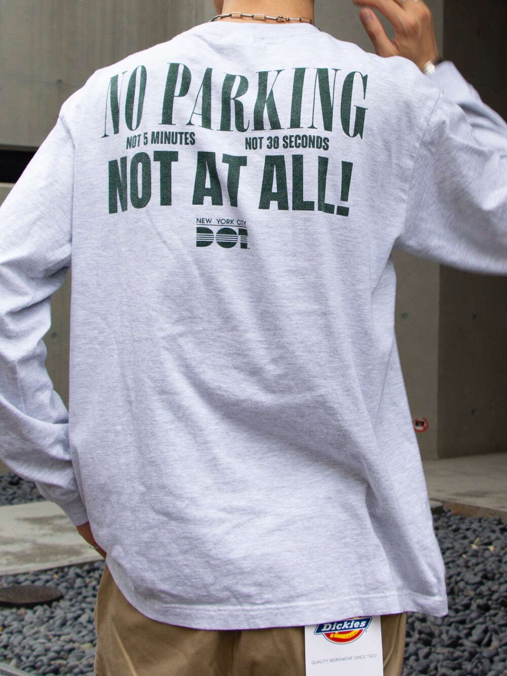 グレー系のTシャツ/カットソー、ベージュ系のチノパンツ、ホワイト系のスニーカーを着用したメンズの夏コーディネートの4枚目の写真