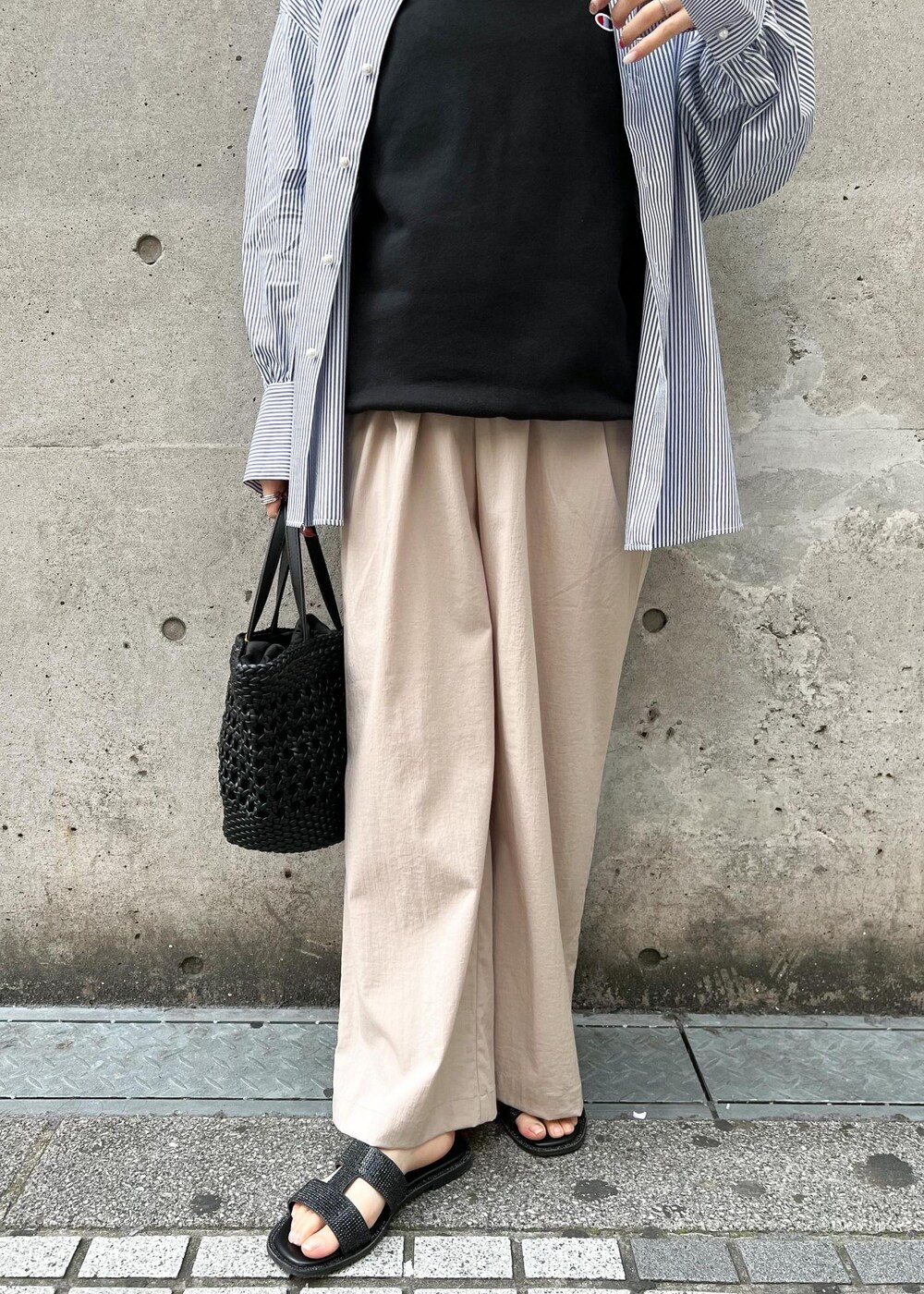 ベージュ系のその他パンツ、ブラック系のトートバッグ、ブルー系のシャツ/ブラウスを着用したレディースの春コーディネートの5枚目の写真