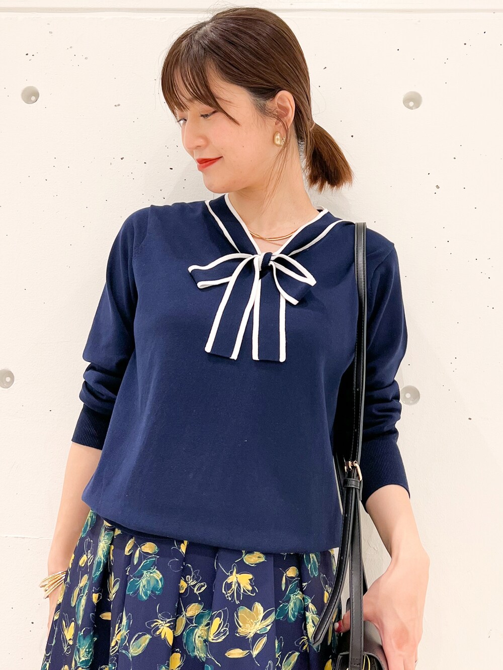 ブルー系のカーディガン/ボレロ、ブルー系のスカート、ブラック系のショルダーバッグを着用したレディースの春コーディネートの4枚目の写真