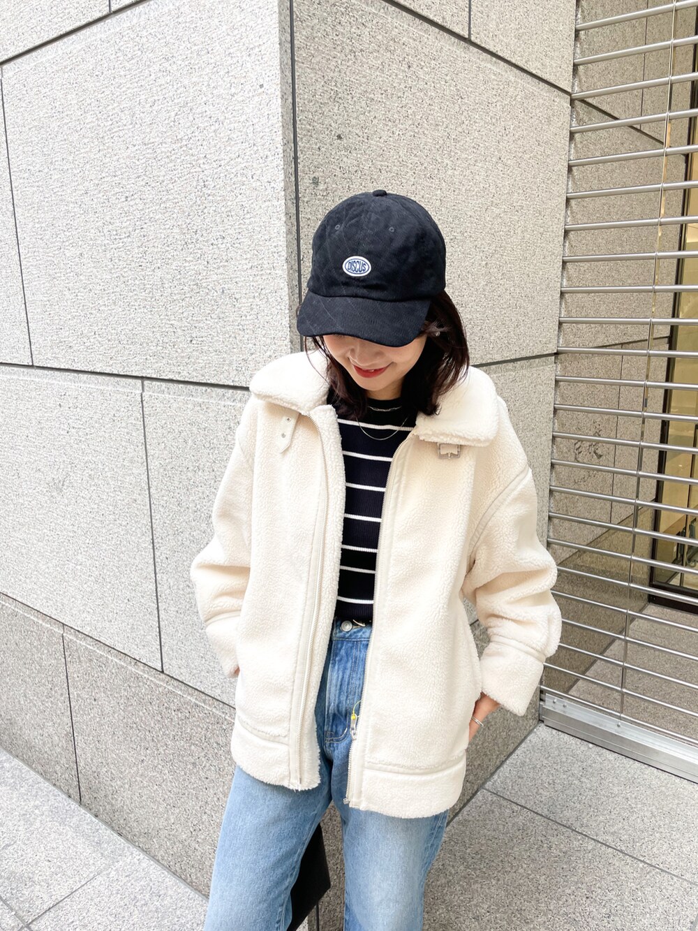 ブラック系のニット/セーター、ブラック系のブーツ、ブルー系のデニムパンツを着用したレディースの冬コーディネートの3枚目の写真