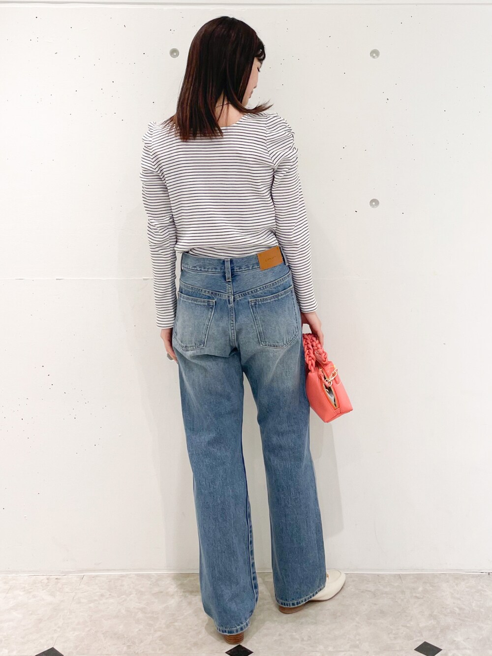 ホワイト系のTシャツ/カットソー、ブルー系のデニムパンツ、ホワイト系のローファーを着用したレディースの春コーディネートの2枚目の写真