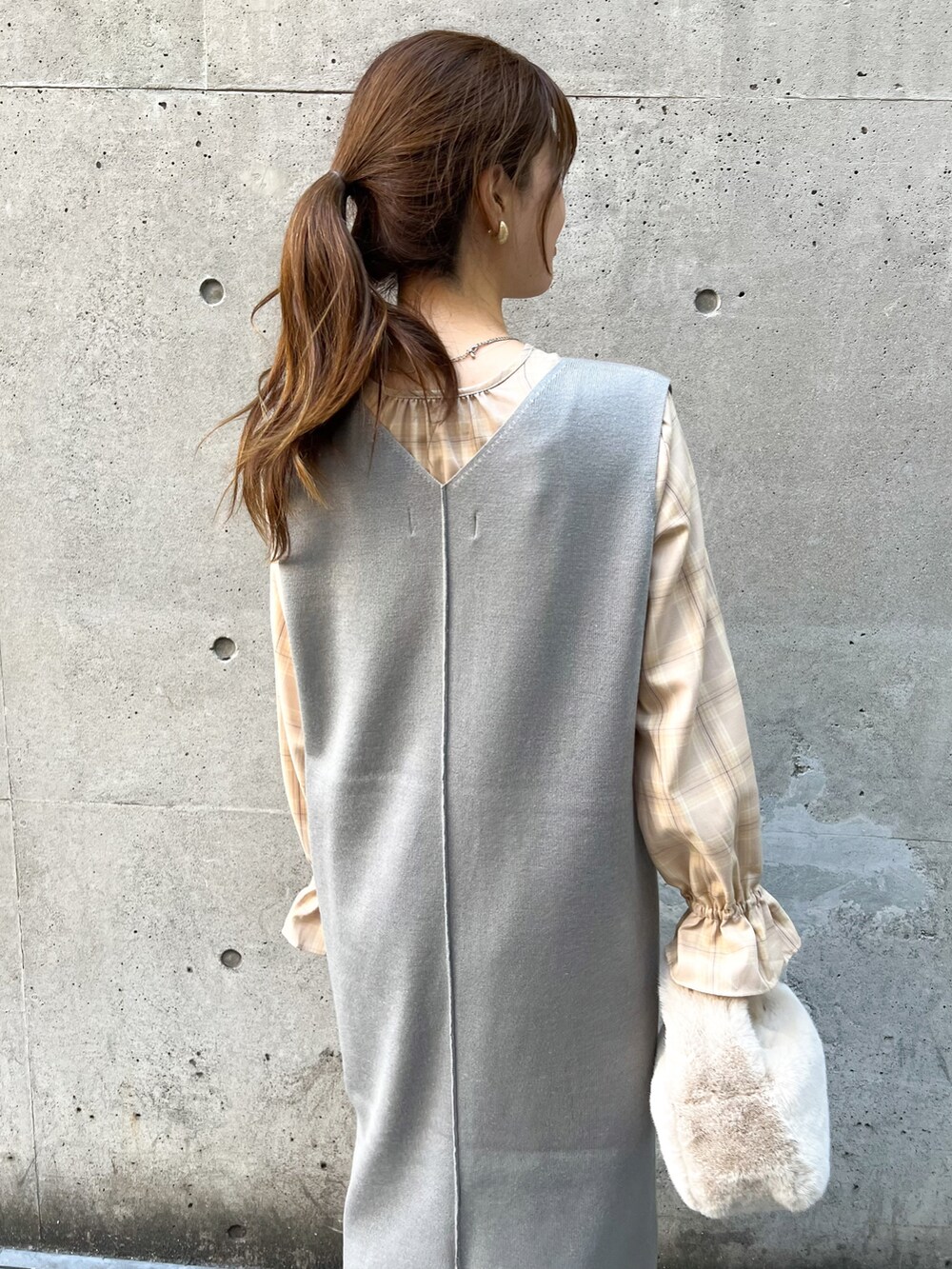 グレー系のジャンパースカート、ベージュ系のショルダーバッグ、ベージュ系のシャツ/ブラウスを着用したレディースの秋コーディネートの5枚目の写真