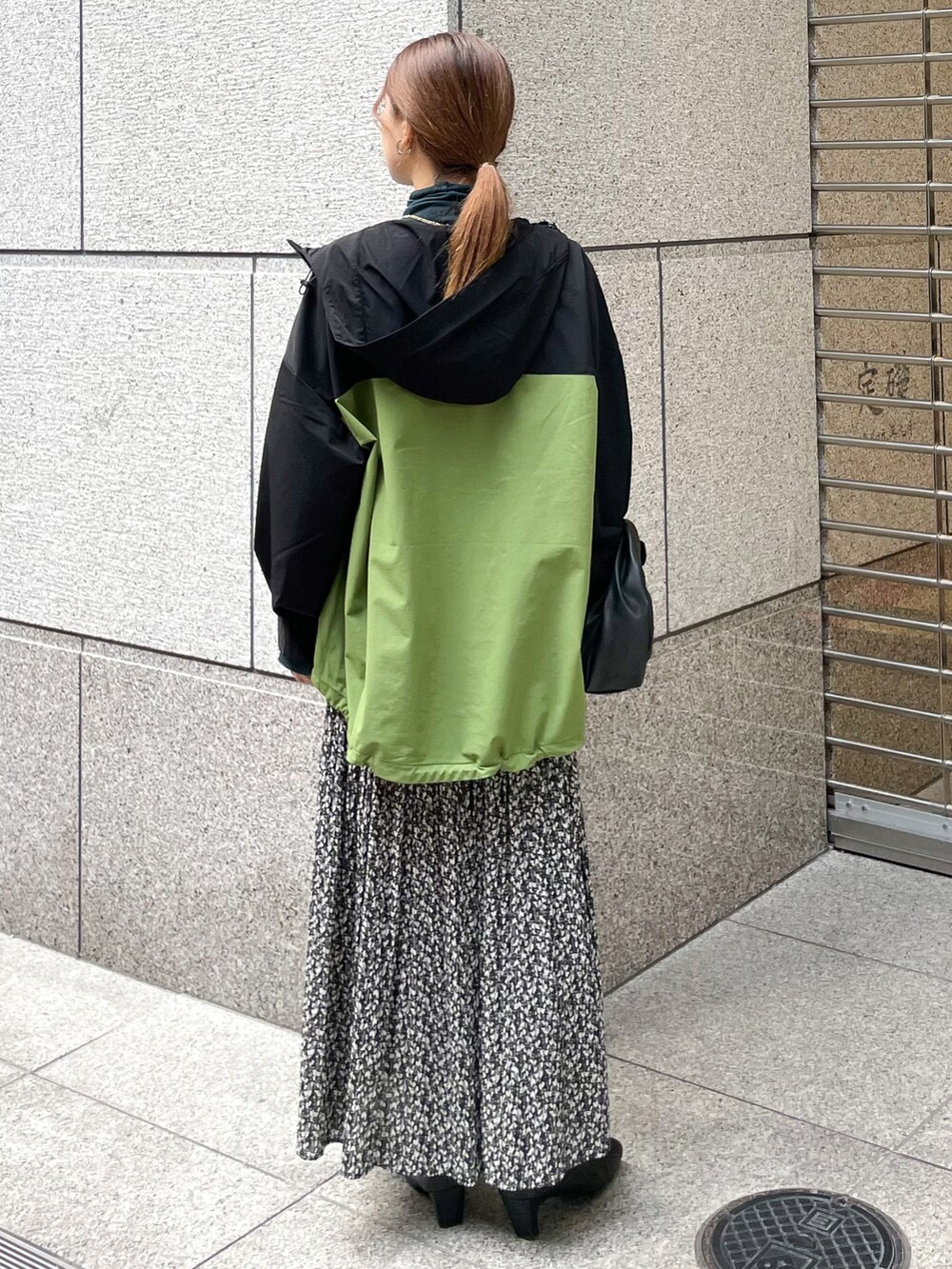 グリーン系のTシャツ/カットソー、グリーン系のマウンテンパーカー、ブラック系のショルダーバッグを着用したレディースの秋コーディネートの2枚目の写真