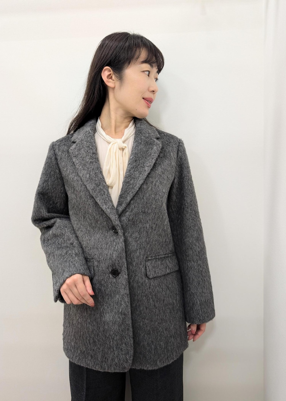 ブラック系のバレエシューズ、レッド系のショルダーバッグ、グレー系のスラックスを着用したレディースの秋コーディネートの4枚目の写真