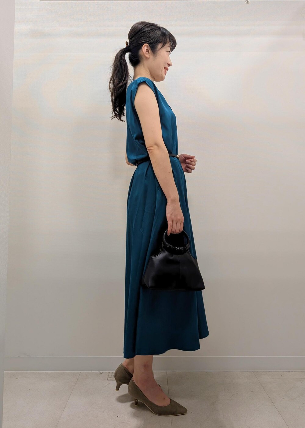 ベージュ系のパンプス、ブルー系のノーカラージャケット、ブラック系のショルダーバッグを着用したレディースの夏コーディネートの3枚目の写真