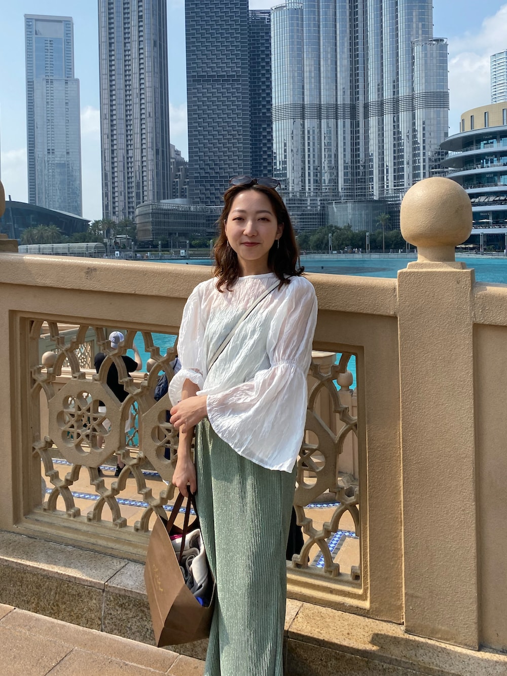 ホワイト系のシャツ/ブラウス、グリーン系のスカートを着用したレディースの春コーディネートの3枚目の写真