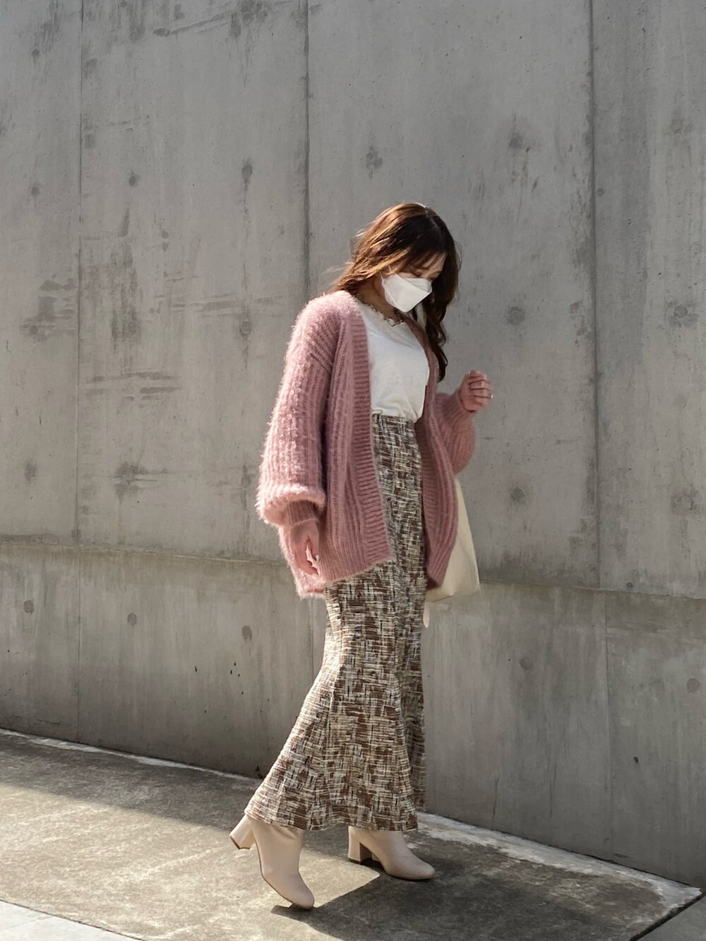 ピンク系のカーディガン/ボレロ、ベージュ系のスカート、ホワイト系のTシャツ/カットソーを着用したレディースの春コーディネートの3枚目の写真