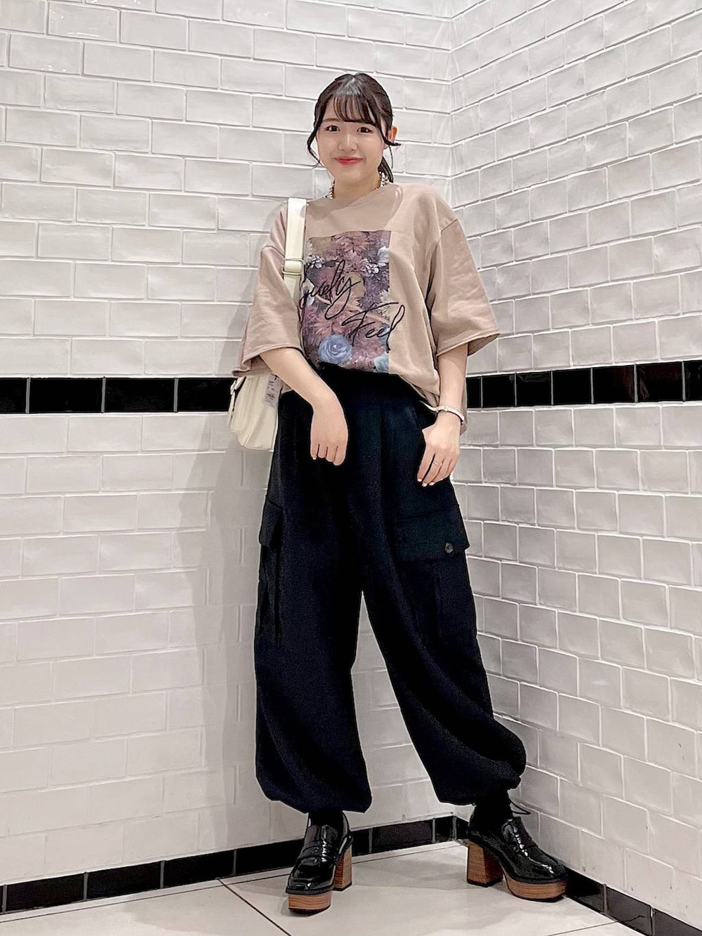 ブラウン系のTシャツ/カットソー、ブラック系のカーゴパンツ、ブラック系のローファーを着用したレディースの秋コーディネートの2枚目の写真