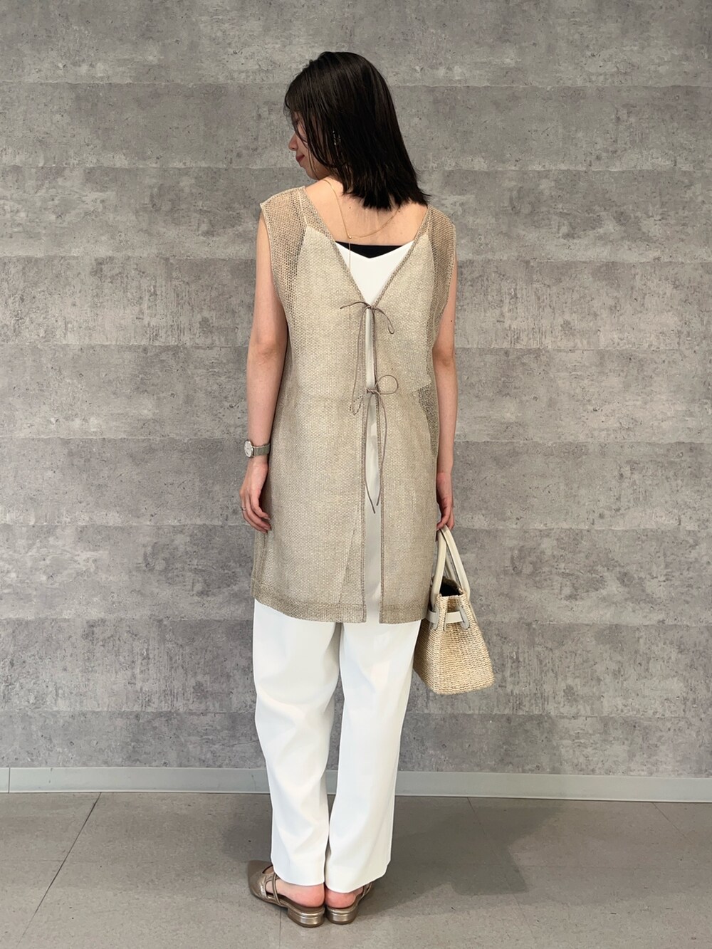 ホワイト系のその他パンツ、ホワイト系のかごバッグ、ホワイト系のキャミソールを着用したレディースの夏コーディネートの3枚目の写真