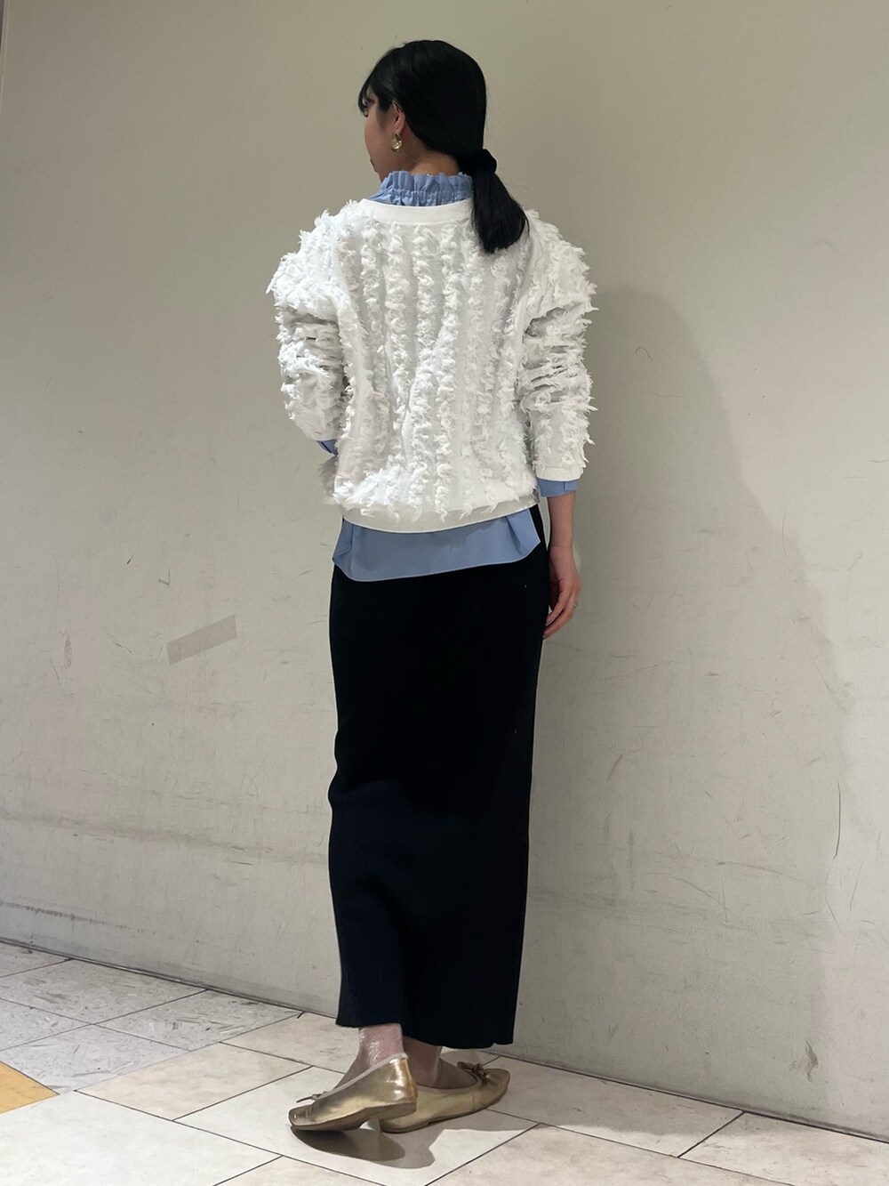 ブラック系のスカート、ブルー系のシャツ/ブラウス、ホワイト系のカーディガン/ボレロを着用したレディースの冬コーディネートの4枚目の写真