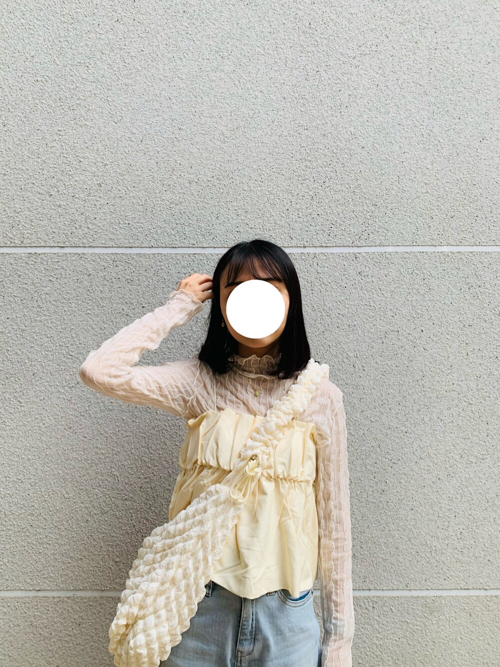 ブルー系のデニムパンツ、ホワイト系のキャミソールを着用したレディースの秋コーディネートの3枚目の写真