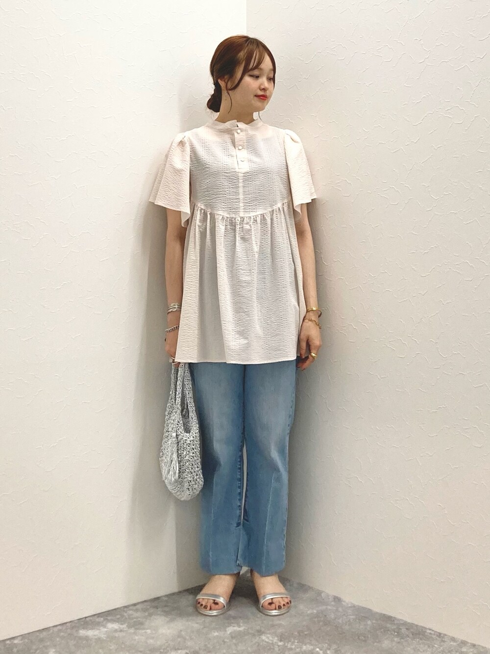 ピンク系のシャツ/ブラウス、ブルー系のデニムパンツ、シルバー系のサンダルを着用したレディースの夏コーディネートの2枚目の写真