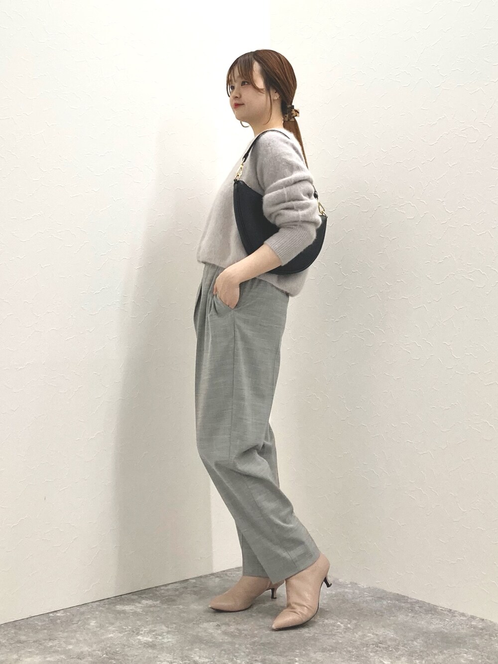 ベージュ系のニット/セーター、ブラック系のショルダーバッグ、グレー系のその他パンツを着用したレディースの冬コーディネートの7枚目の写真