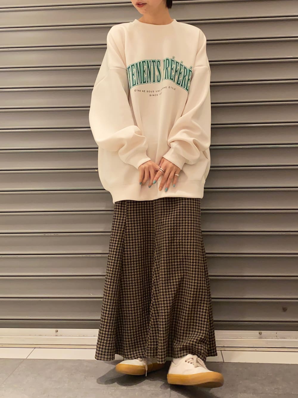 ホワイト系のスウェット、ブラウン系のスカートを着用したレディースの春コーディネートの3枚目の写真