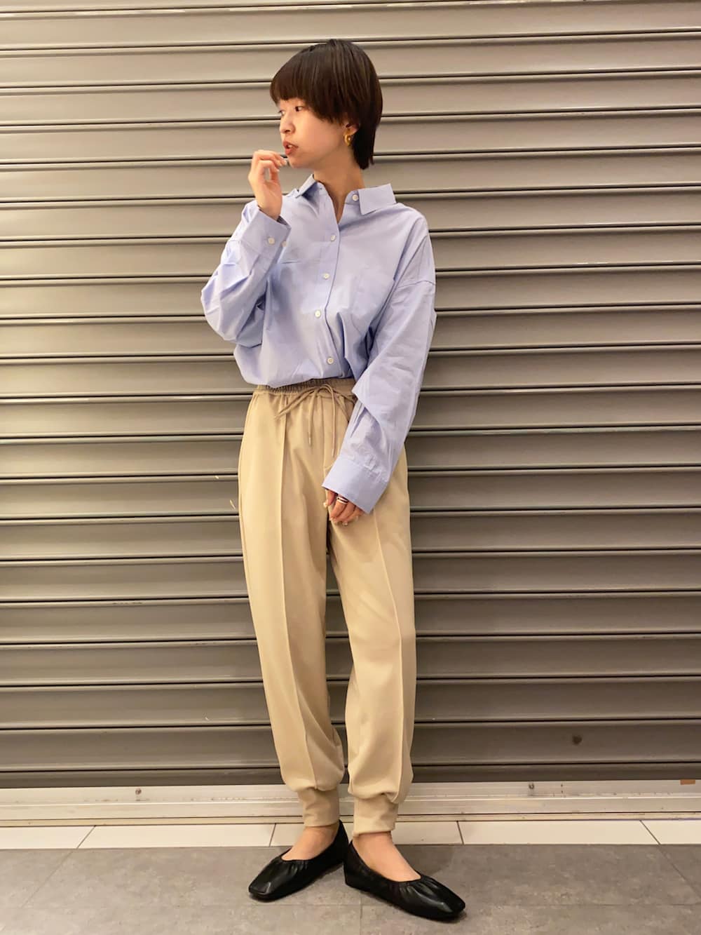 ブラック系のシューズ、ベージュ系のパンツ、ブルー系のシャツ/ブラウスを着用したレディースの春コーディネートの2枚目の写真