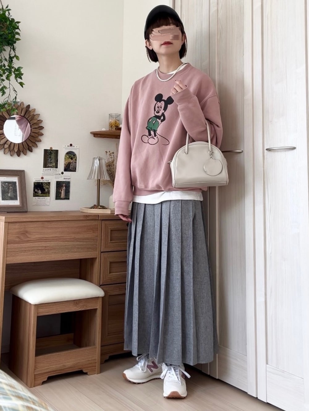 ピンク系のスウェット、ブラウン系のスカート、ホワイト系のボストンバッグを着用したレディースの春コーディネートの4枚目の写真