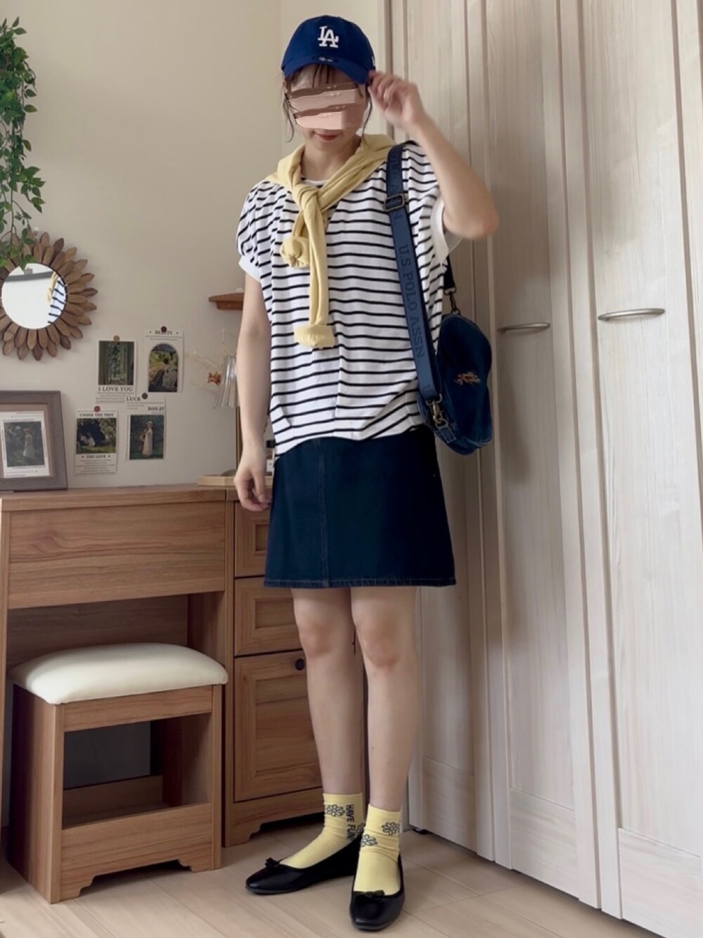 ホワイト系のTシャツ/カットソー、ブラック系のバレエシューズ、ブルー系のデニムスカートを着用したレディースの夏コーディネートの3枚目の写真