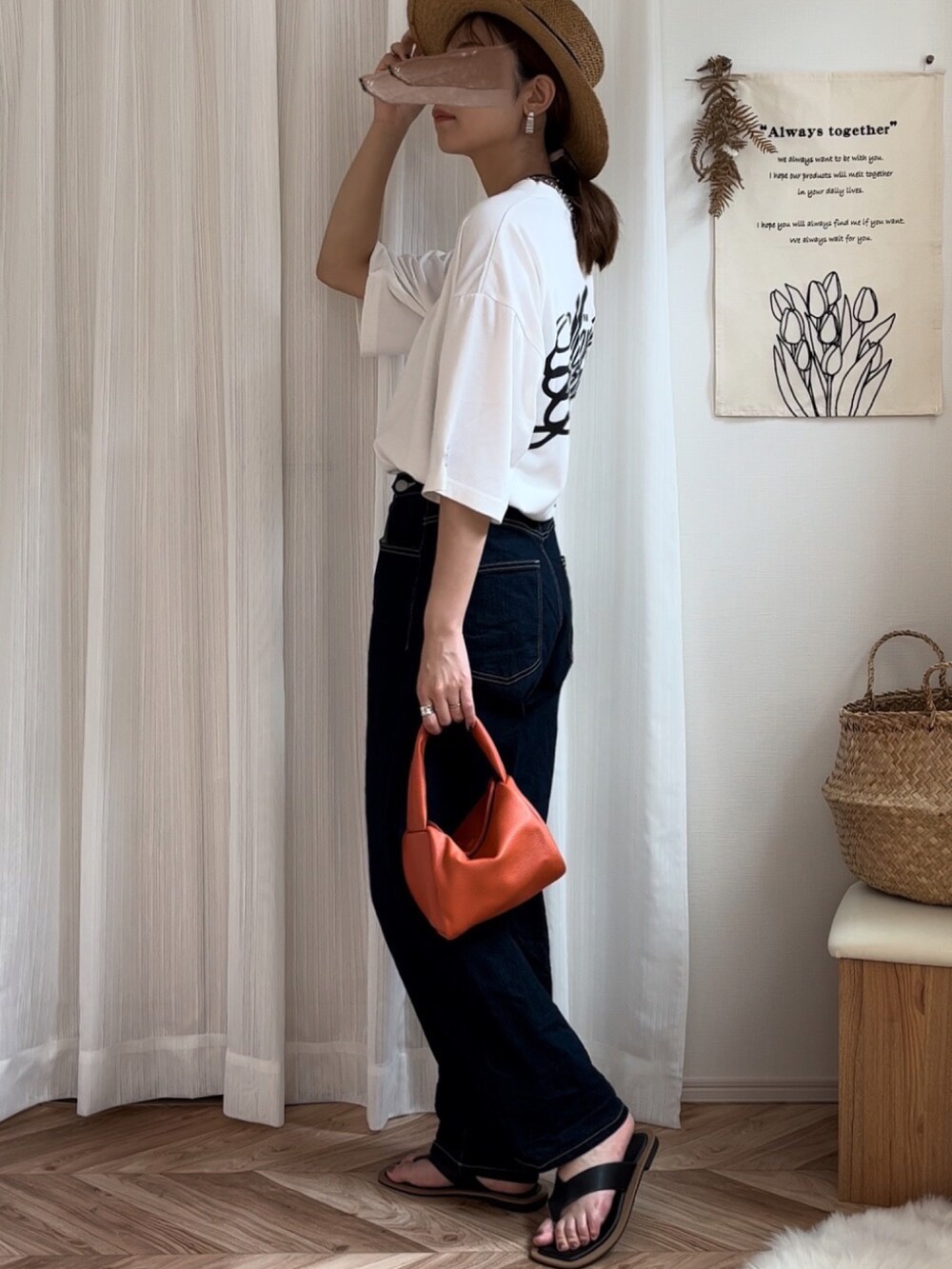 ホワイト系のTシャツ/カットソー、ブルー系のデニムパンツ、オレンジ系のハンドバッグを着用したレディースの夏コーディネートの3枚目の写真