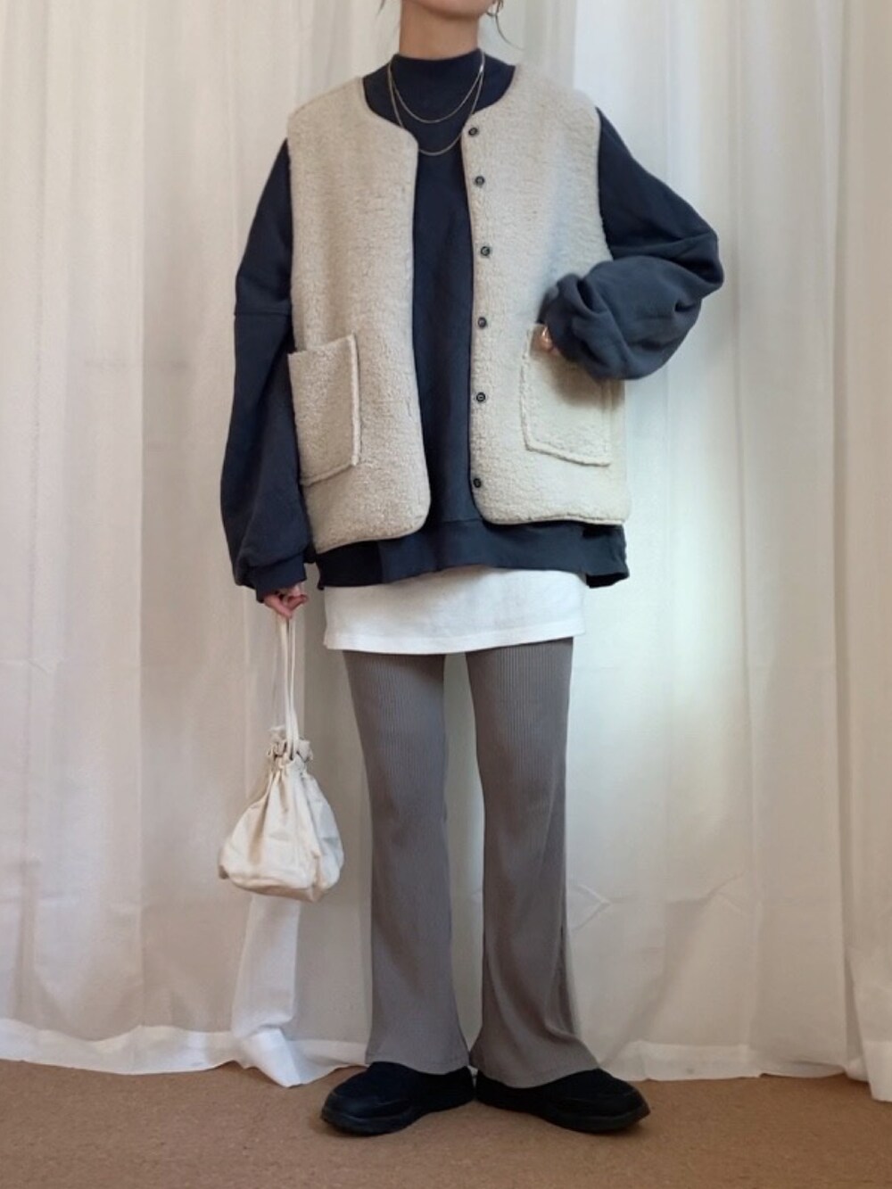 グレー系のスウェット、ホワイト系のショルダーバッグ、ブラック系のシューズを着用したレディースの秋コーディネートの3枚目の写真