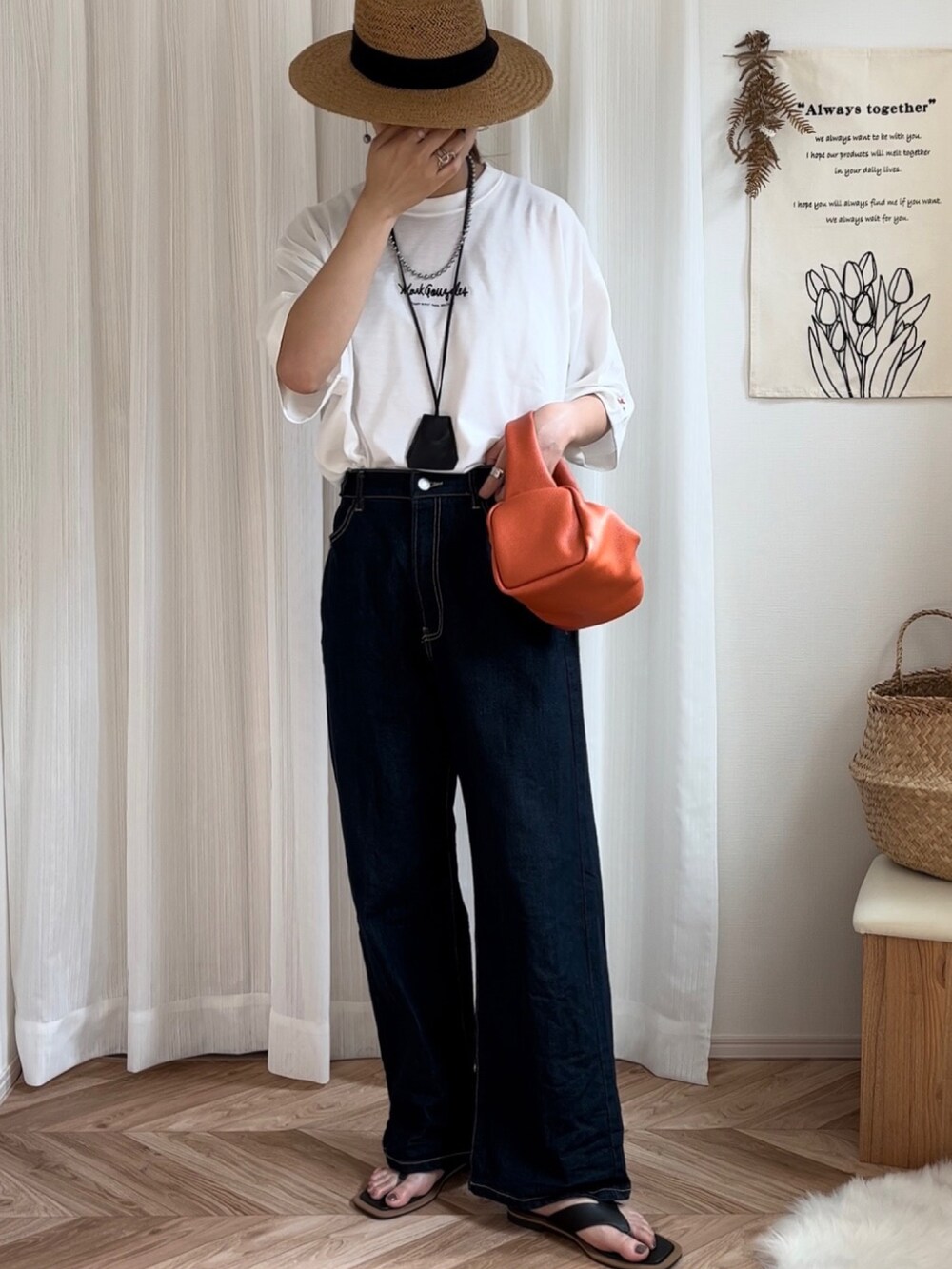 ホワイト系のTシャツ/カットソー、ブルー系のデニムパンツ、オレンジ系のハンドバッグを着用したレディースの夏コーディネートの2枚目の写真