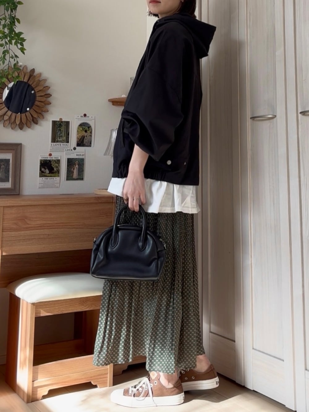 ホワイト系のマウンテンパーカー、グリーン系のスカートを着用したレディースの春コーディネートの2枚目の写真