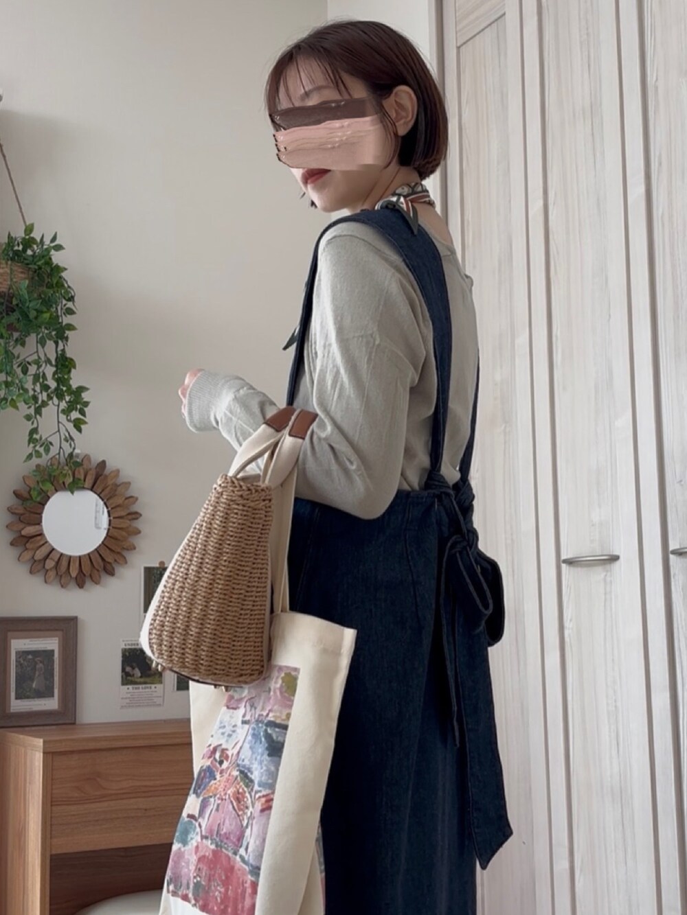 グリーン系のカーディガン/ボレロ、ブルー系のジャンパースカートを着用したレディースの冬コーディネートの3枚目の写真