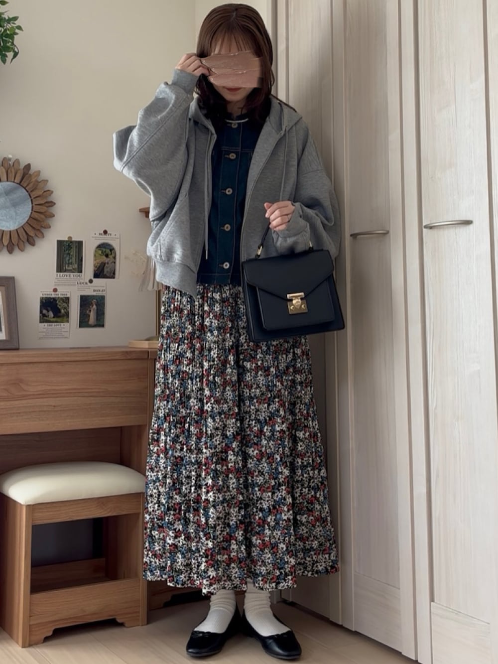 グレー系のパーカー、ブルー系のブルゾン、レッド系のスカートを着用したレディースの冬コーディネートの2枚目の写真