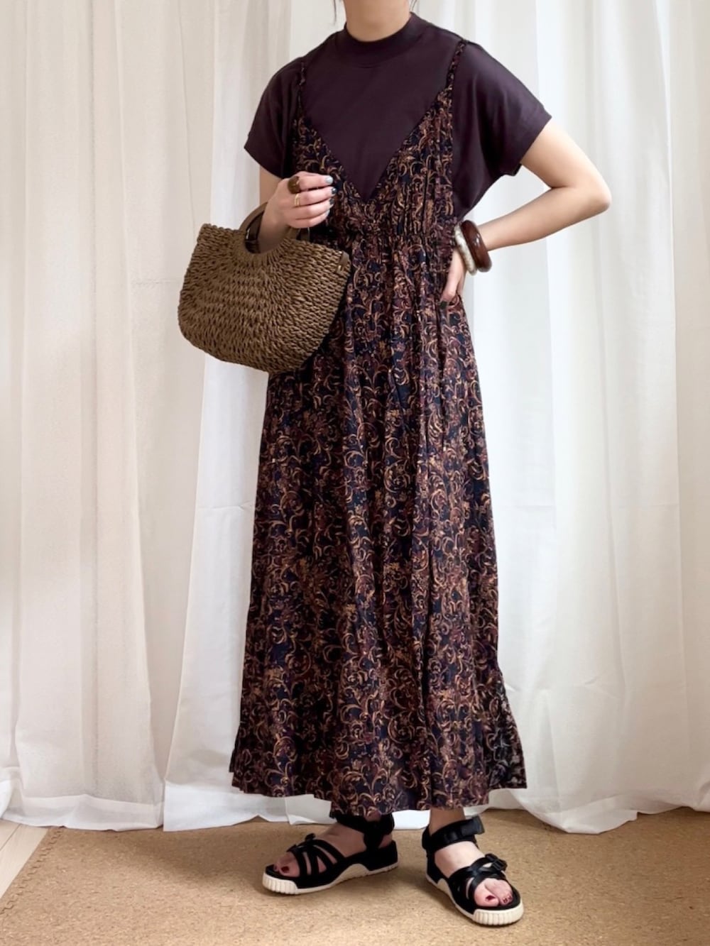 ブラック系のワンピース、ブラウン系のTシャツ/カットソー、ブラウン系のショルダーバッグを着用したレディースの春コーディネートの2枚目の写真