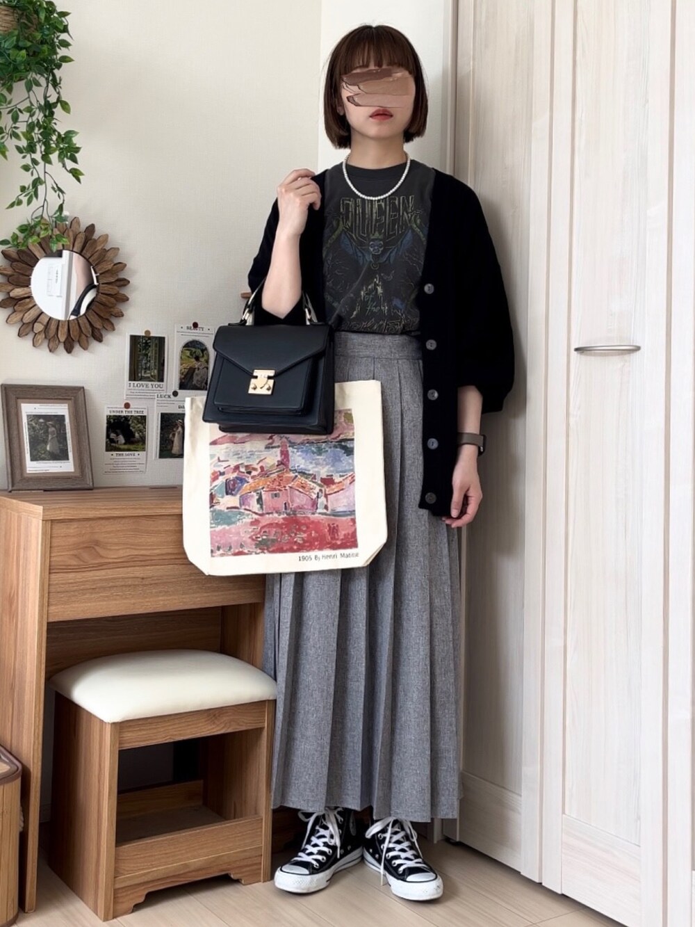 グレー系のTシャツ/カットソー、ブラック系のカーディガン/ボレロ、グレー系のスカートを着用したレディースの春コーディネートの5枚目の写真