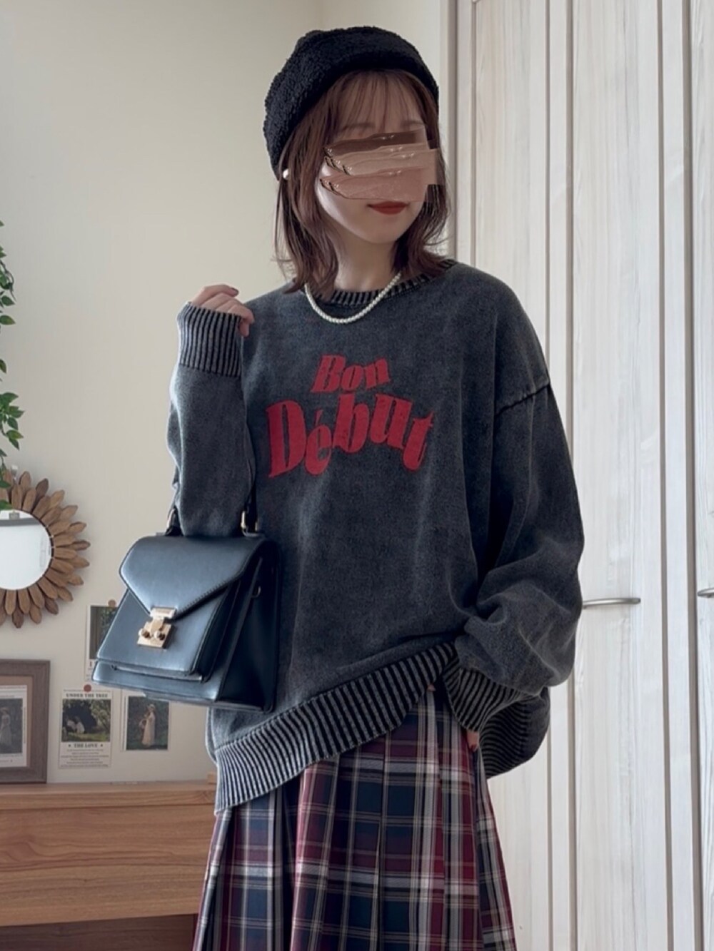 ブラック系のニット/セーター、ブラック系のブーツ、ブルー系のスカートを着用したレディースの秋コーディネートの2枚目の写真