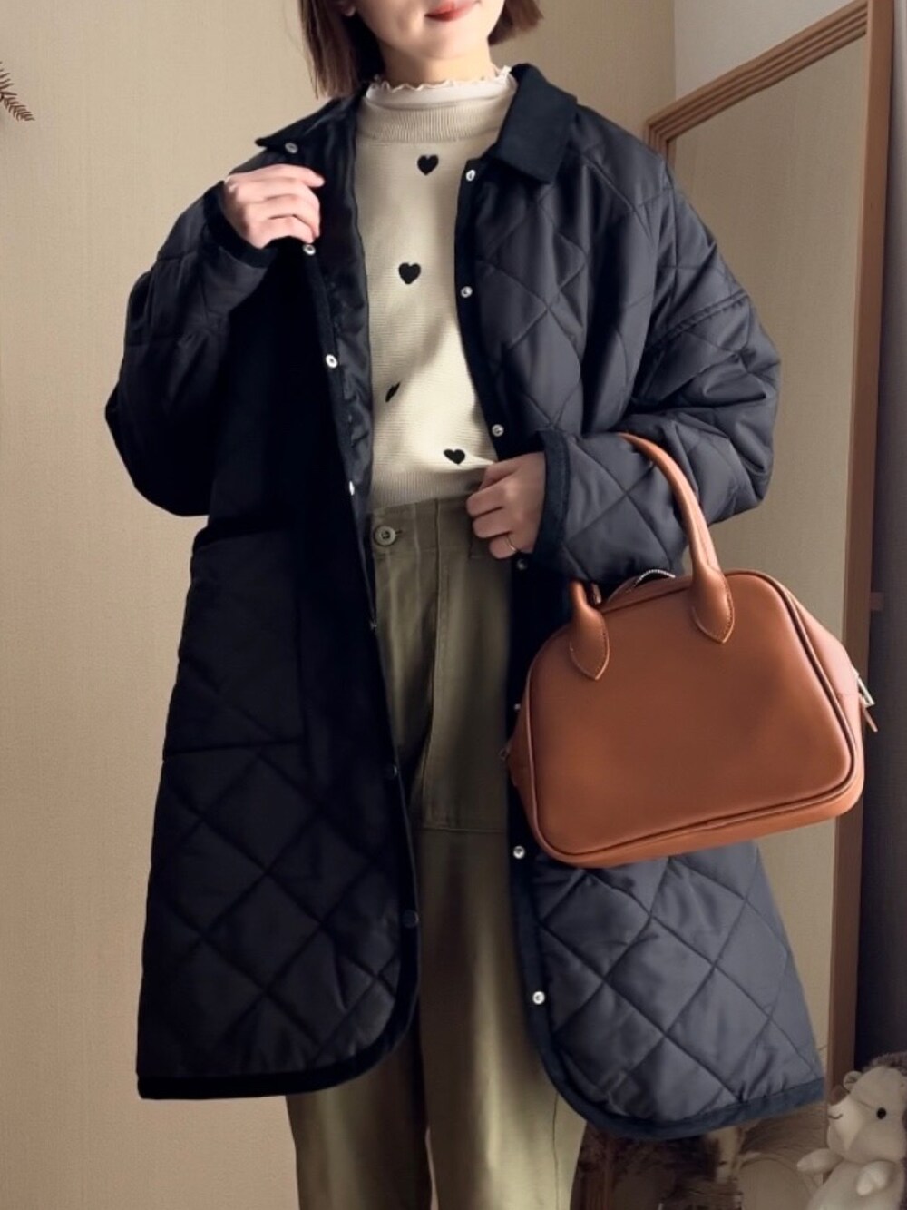 ベージュ系のカーディガン/ボレロ、グリーン系のその他パンツ、イエロー系のボストンバッグを着用したレディースの春コーディネートの2枚目の写真