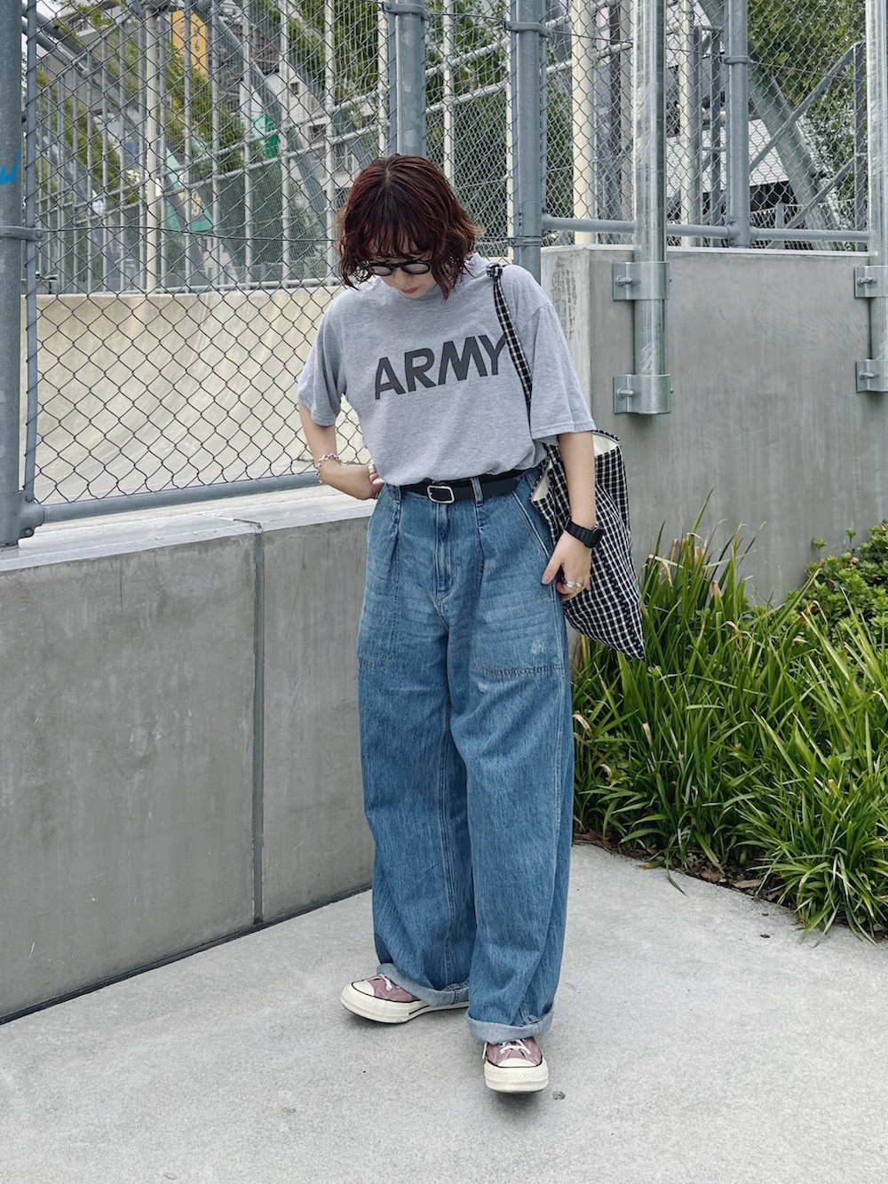 グレー系のTシャツ/カットソー、ブルー系のデニムパンツ、ブラック系のベルトを着用したレディースの秋コーディネートの2枚目の写真