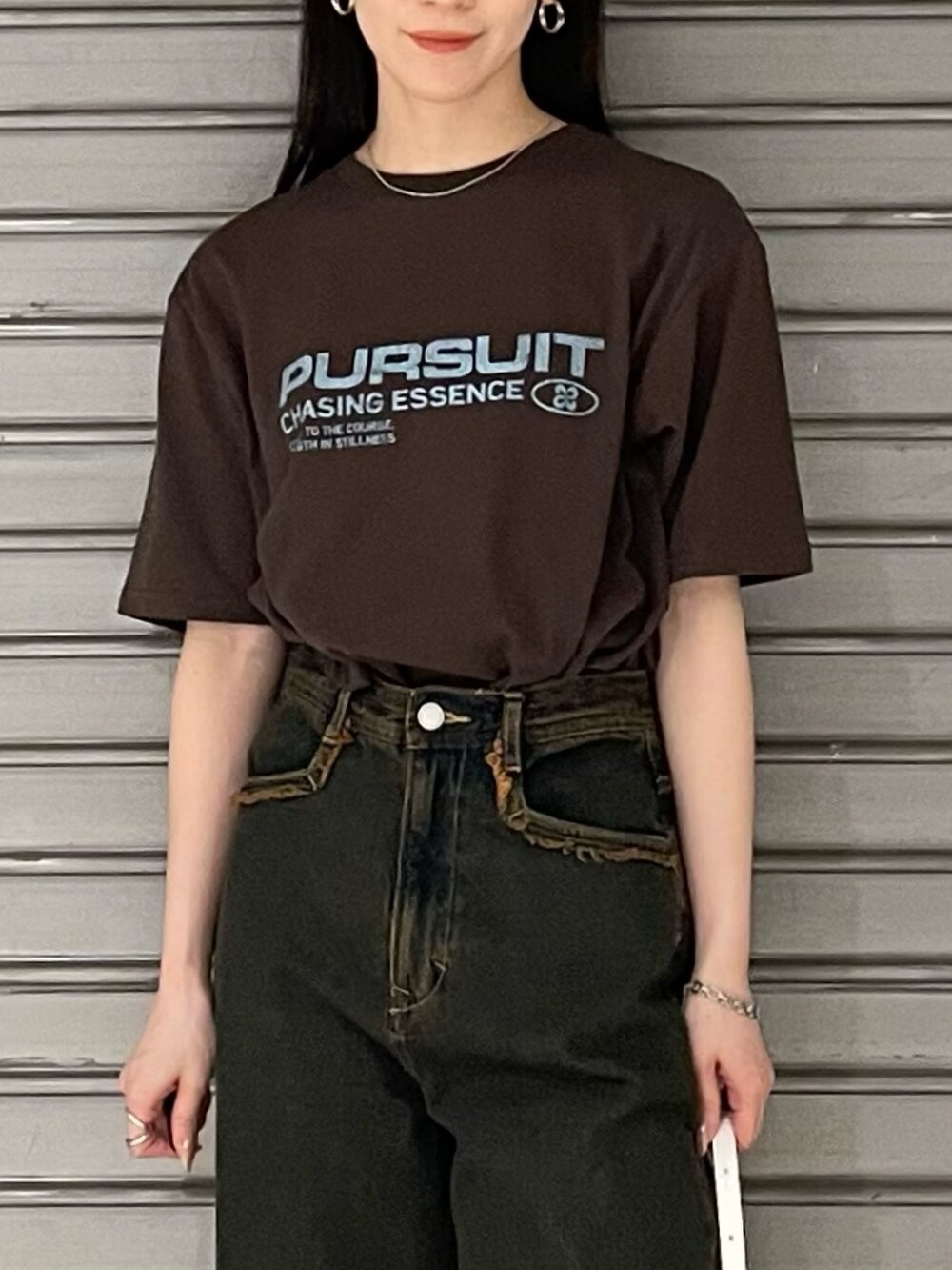 ブラウン系のTシャツ/カットソー、ブルー系のデニムパンツ、ホワイト系のパンプスを着用したレディースの春コーディネートの5枚目の写真