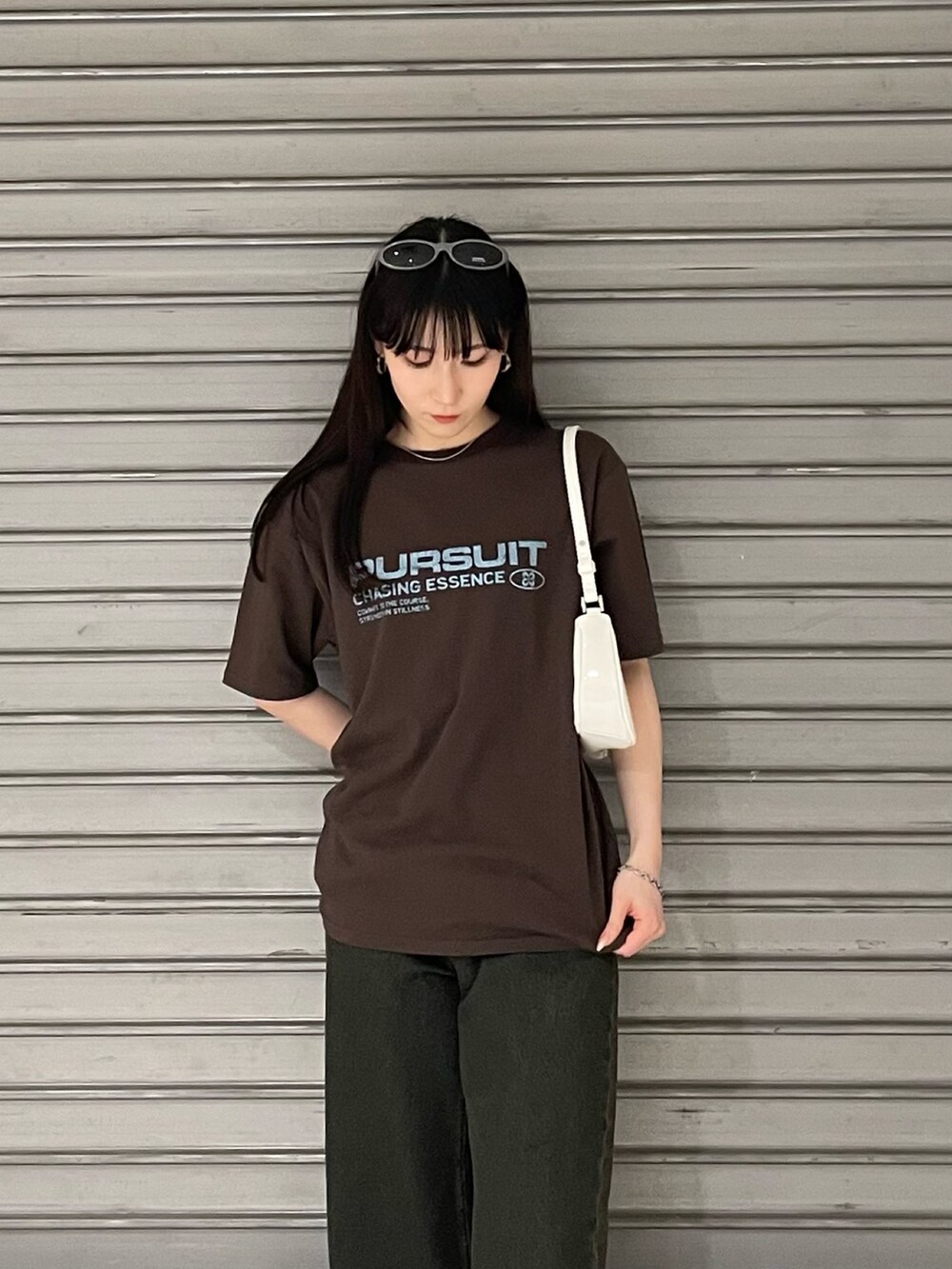 ブラウン系のTシャツ/カットソー、ブルー系のデニムパンツ、ホワイト系のパンプスを着用したレディースの春コーディネートの4枚目の写真