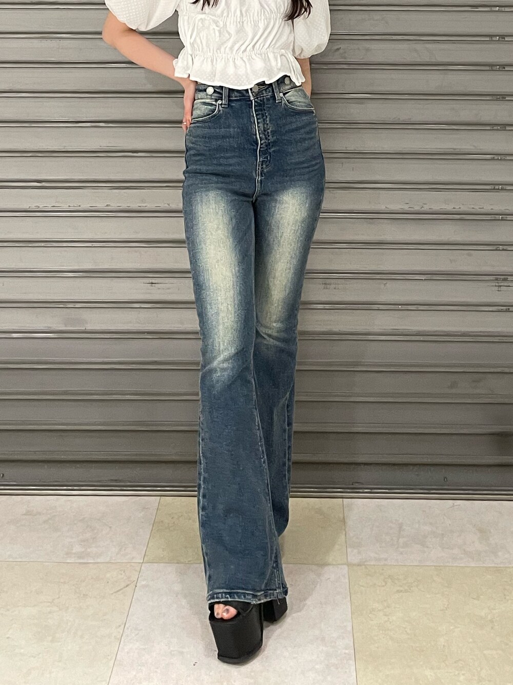 ホワイト系のTシャツ/カットソー、ブルー系のサロペット/オーバーオール、ブラック系のサンダルを着用したレディースの春コーディネートの7枚目の写真