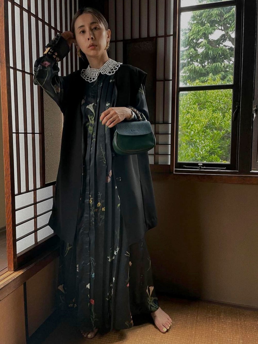 ブラック系のワンピース、ゴールド系のピアス（両耳用）、ホワイト系のチョーカーを着用したレディースの秋コーディネートの3枚目の写真