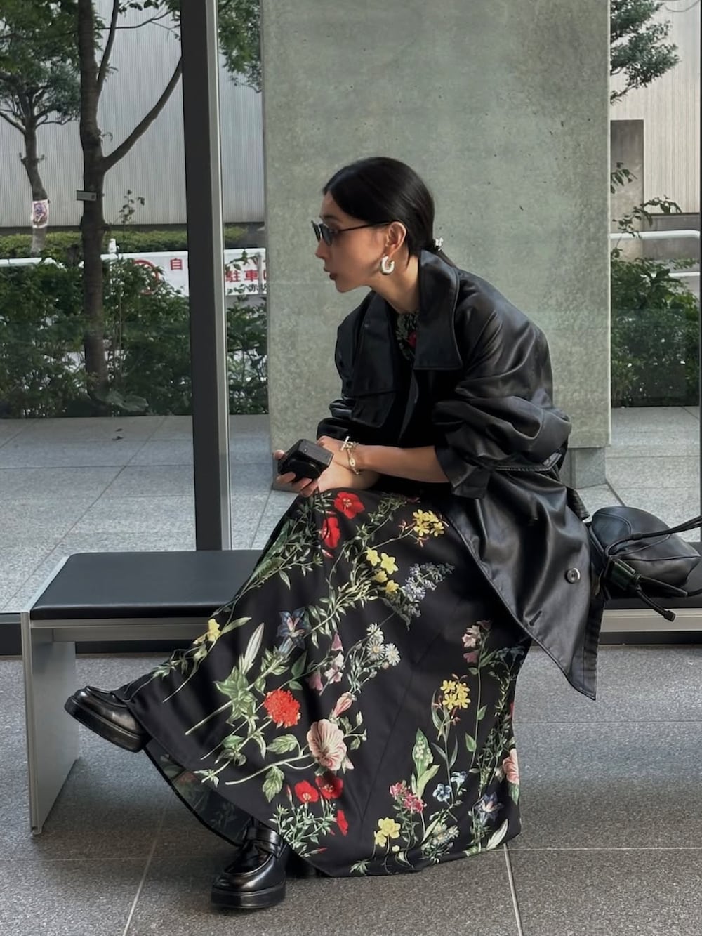 ブラック系のワンピース、ブラック系のトレンチコートを着用したレディースの秋コーディネートの3枚目の写真