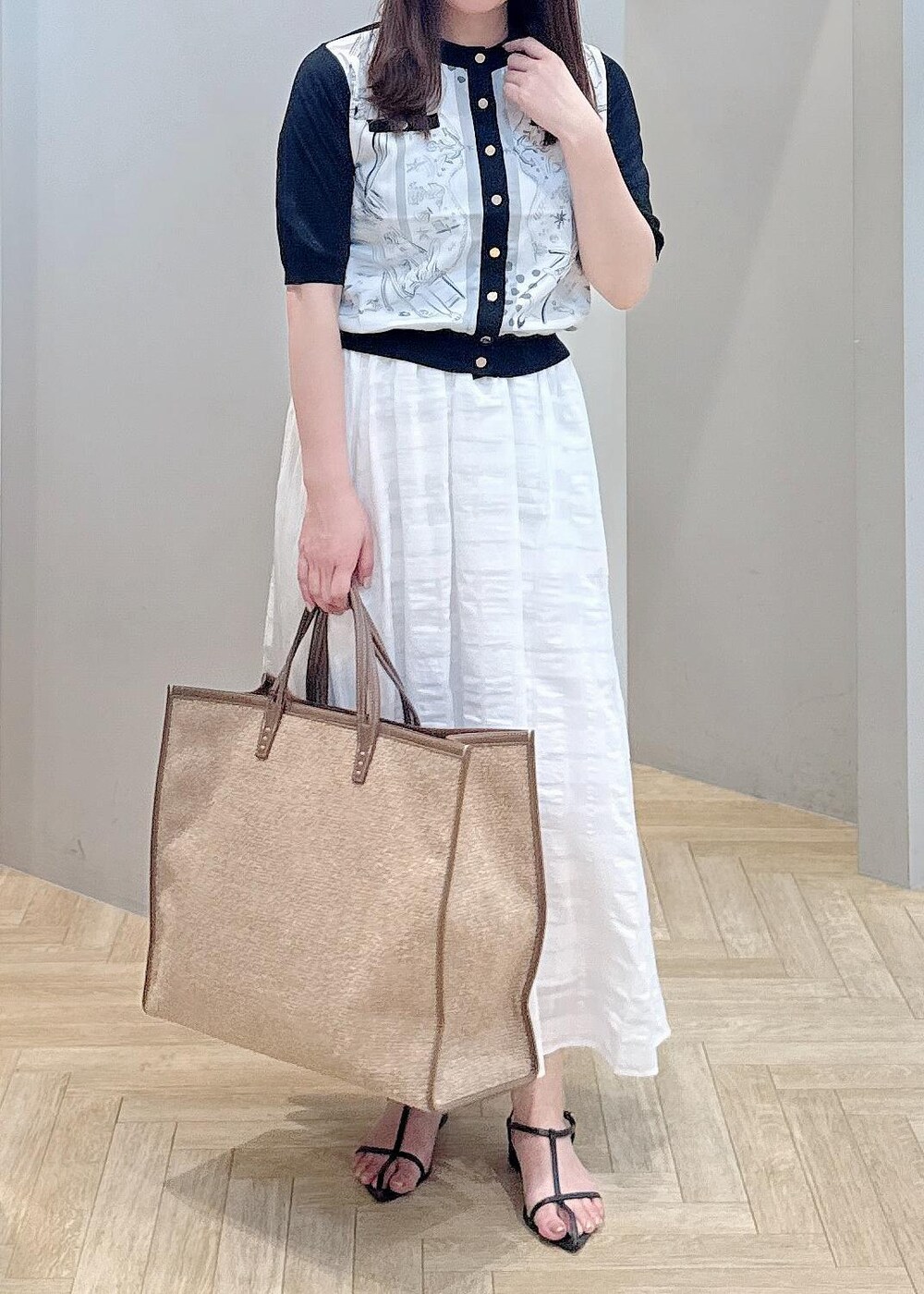 ホワイト系のスカート、ブラック系のシャツ/ブラウスを着用したレディースの夏コーディネートの4枚目の写真