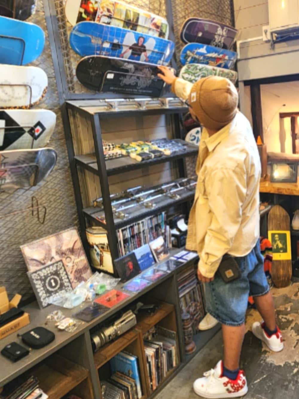 ホワイト系のスニーカー、ブルー系のデニムパンツ、ベージュ系のシャツ/ブラウスを着用したメンズの春コーディネートの4枚目の写真